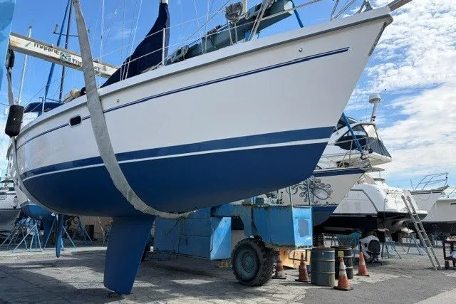 Slide: The Image of Catalina 380 sailboat from 2000 in dry dock, showcasing hull and keel. - 27