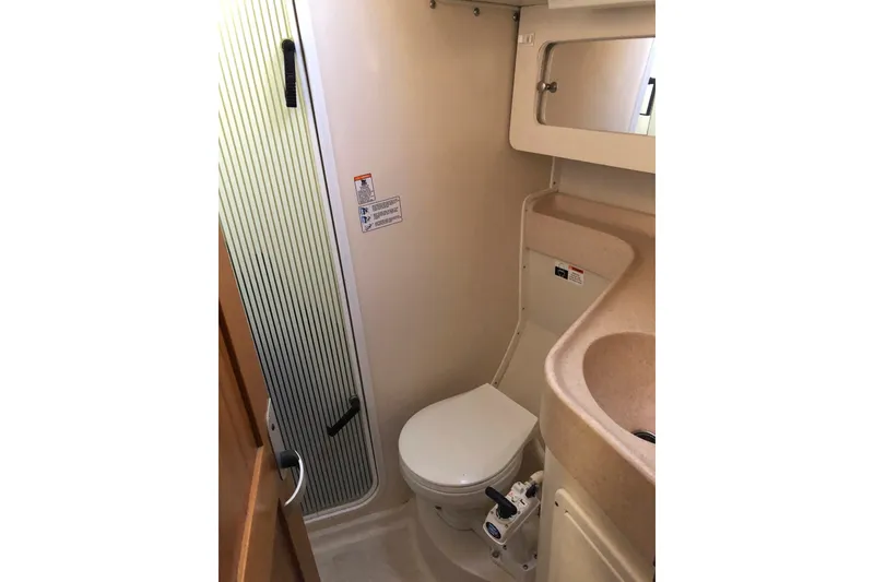 Slide: The Image of Bathroom interior of a 2000 Catalina 380 yacht, featuring a toilet and sink. - 11
