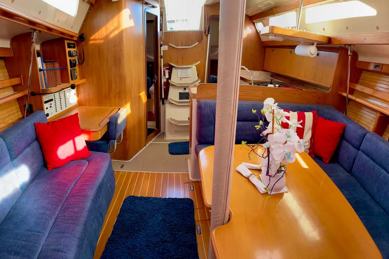 Slide: The Image of Interior of a 2000 Catalina 380 sailboat with cozy seating and wooden finishes. - 14