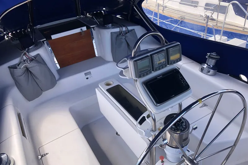 Slide: The Image of Cockpit of 2000 Catalina 380 sailboat with navigation instruments and steering wheel. - 22