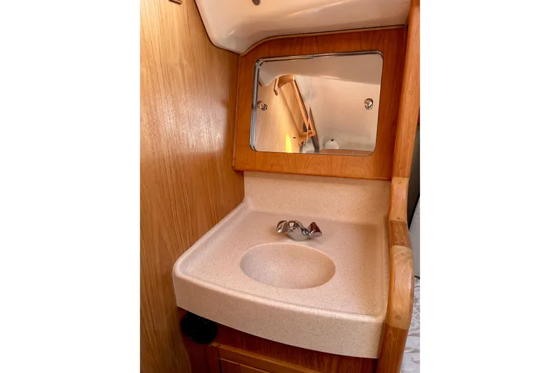 Slide: The Image of Compact bathroom sink with mirror in 2000 Catalina 380 yacht interior. - 12