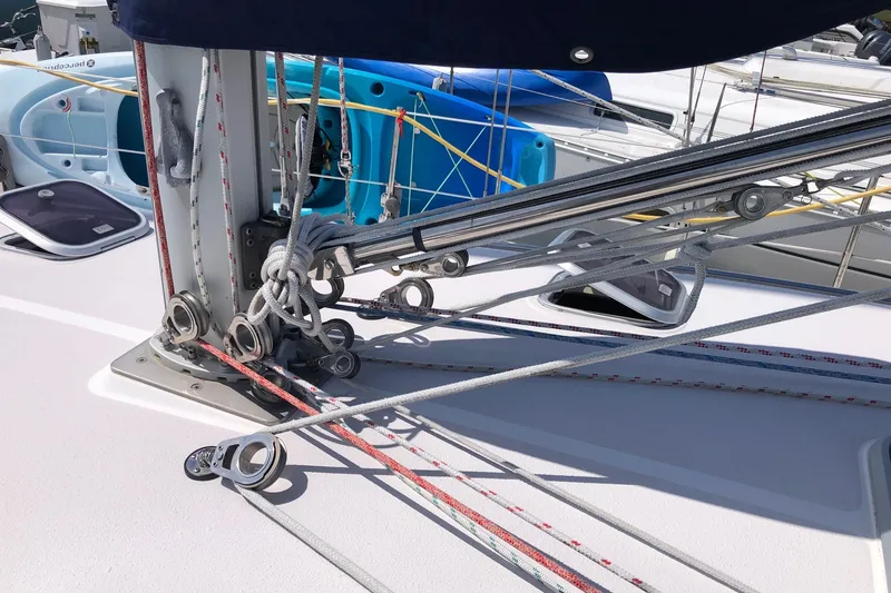 Slide: The Image of Rope rigging on a 2000 Catalina 380 sailboat deck, showcasing pulleys and lines. - 16