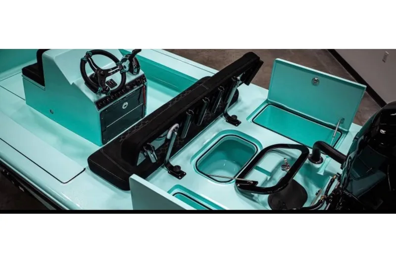 Slide: The Image of Interior view of 2025 V Tech 18 Flats boat, featuring steering console and storage compartments. - 2