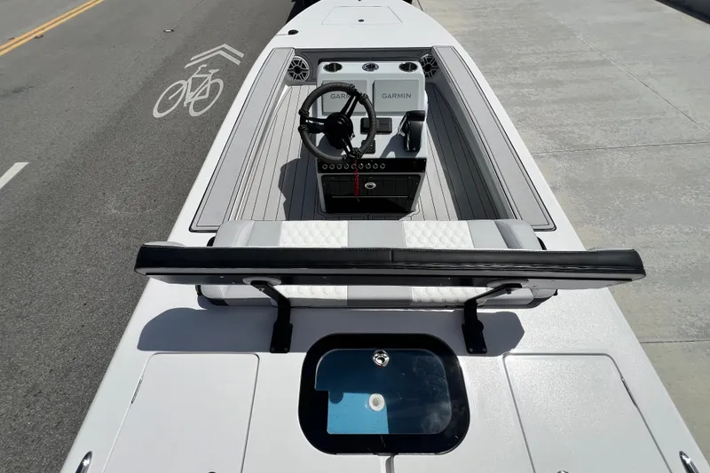 Slide: The Image of 2025 Vtech 18 boat with Garmin navigation, parked on a road with bike lane markings. - 49