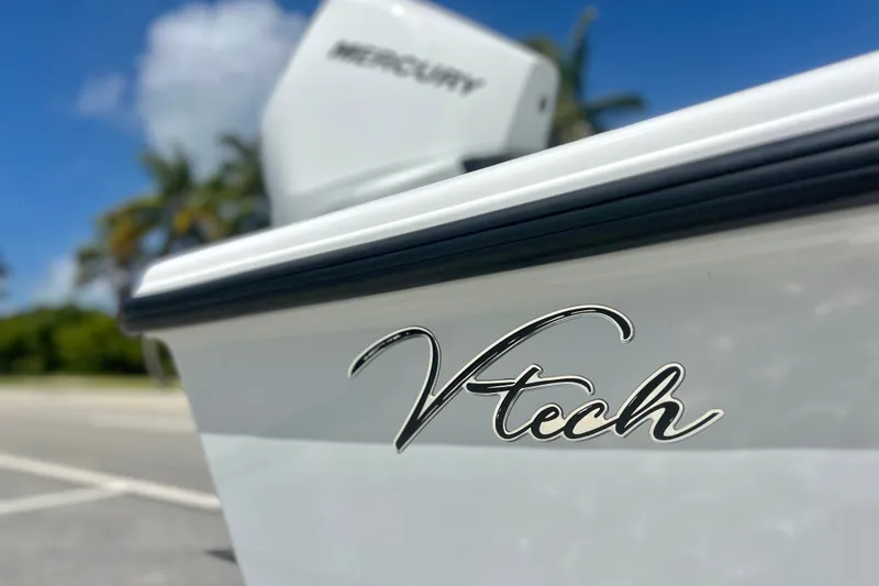 Slide: The Image of 2025 Vtech 18 boat with Mercury engine, parked near palm trees under blue sky. - 78