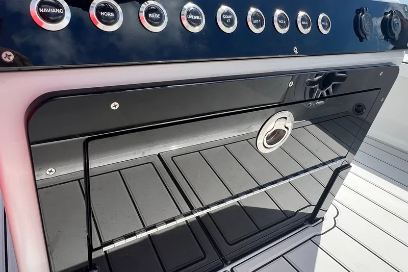 Slide: The Image of Control panel of a 2025 Vtech 18 boat with various switches and sleek design. - 76
