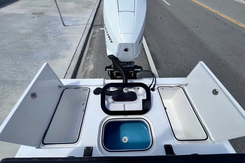 Slide: The Image of Open compartments on a Vtech 18 boat, showcasing storage and engine, 2025 model. - 44