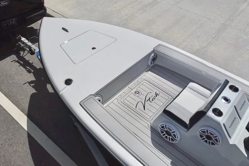 Slide: The Image of Modern Vtech 18 boat, 2025 model, with sleek design and advanced features, parked on trailer. - 27