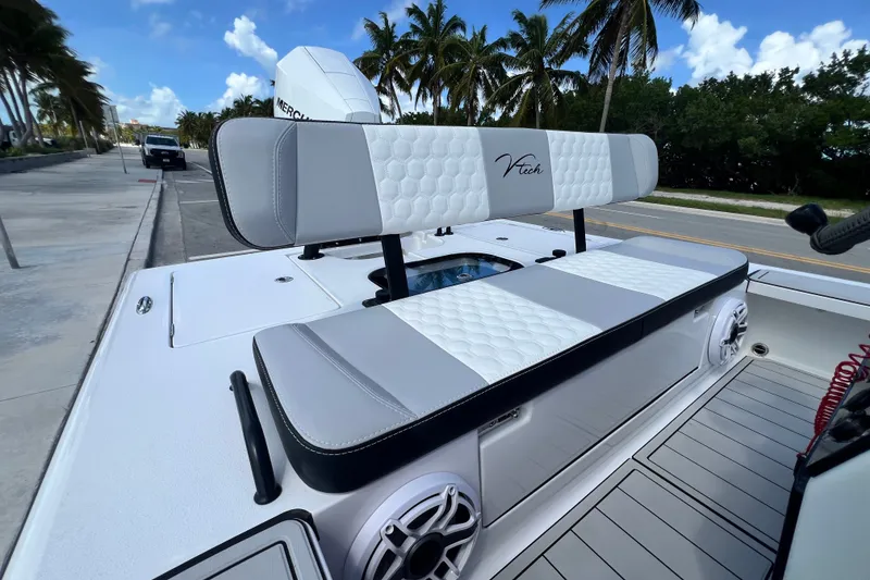 Slide: The Image of Vtech 18 boat interior with stylish seating, palm trees, and clear blue sky, 2025 model. - 40