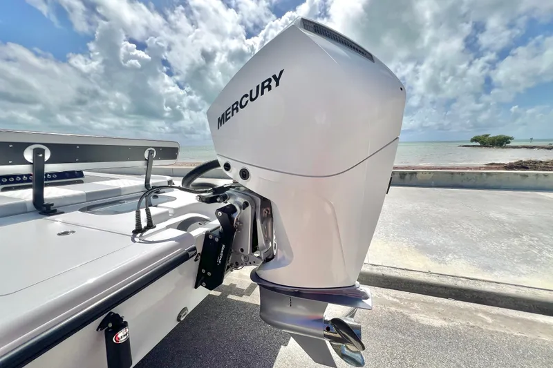 Slide: The Image of Custom Vtech 18 Flats 2025 boat with Mercury outboard motor by the ocean. - 11