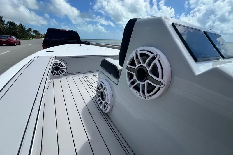 Slide: The Image of Vtech 18 boat, 2025 model, on trailer by ocean road, featuring sleek design and speakers. - 57