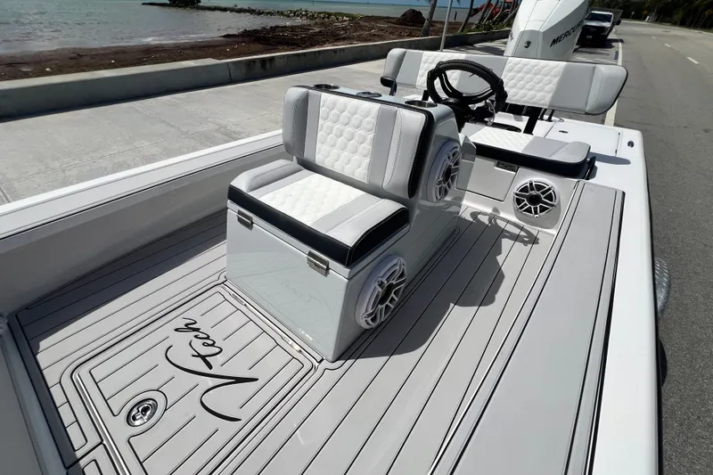 Slide: The Image of Vtech 18 boat interior, 2025 model, featuring sleek seating and modern design by the water. - 32