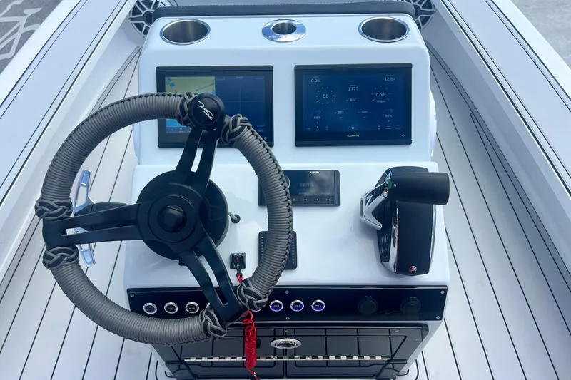 Slide: The Image of Steering console of 2025 Vtech 18 boat with dual screens and controls. - 51