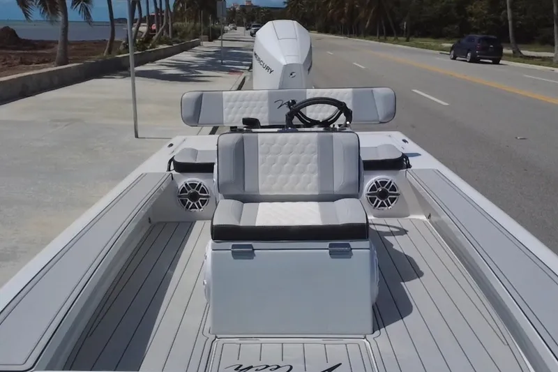 Slide: The Image of 2025 Vtech 18 boat with sleek seating and modern design on a coastal road. - 29