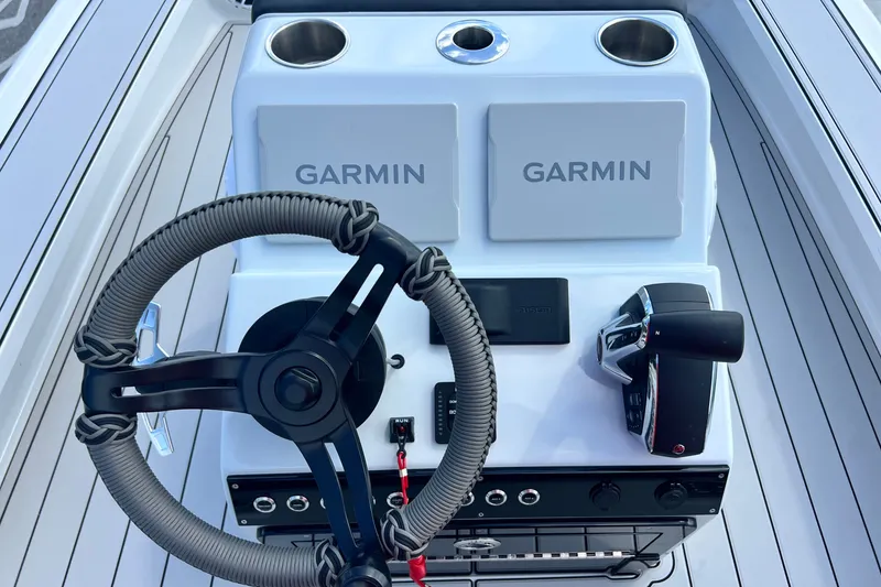 Slide: The Image of Boat dashboard with Garmin displays, steering wheel, and controls, Vtech model 18, year 2025. - 50