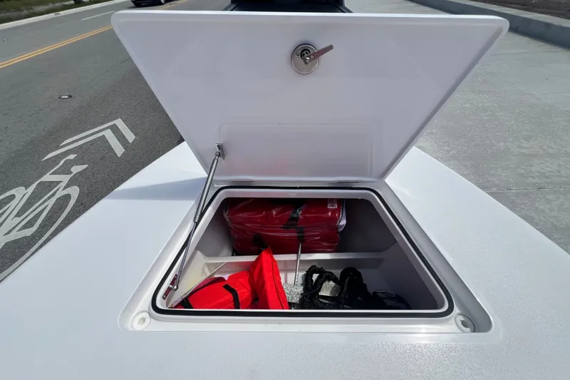 Slide: The Image of Open storage compartment on Vtech 18 model, 2025, containing red and black items. - 67