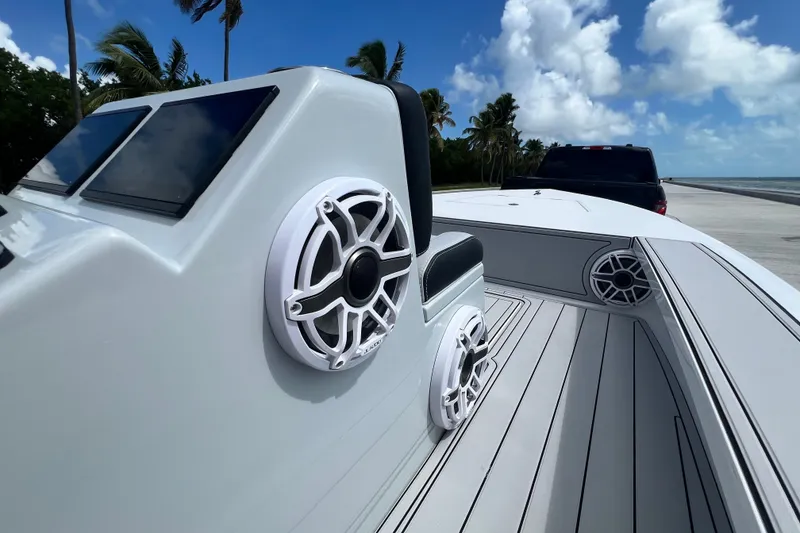 Slide: The Image of 2025 Vtech 18 boat with sleek design, modern speakers, and ocean backdrop. - 58
