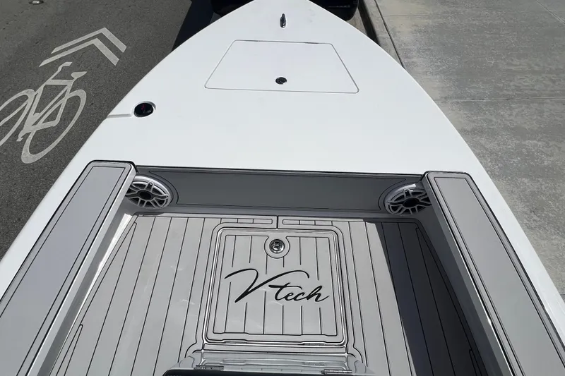 Slide: The Image of Front deck of a 2025 Vtech 18 boat with sleek design and speakers. - 62