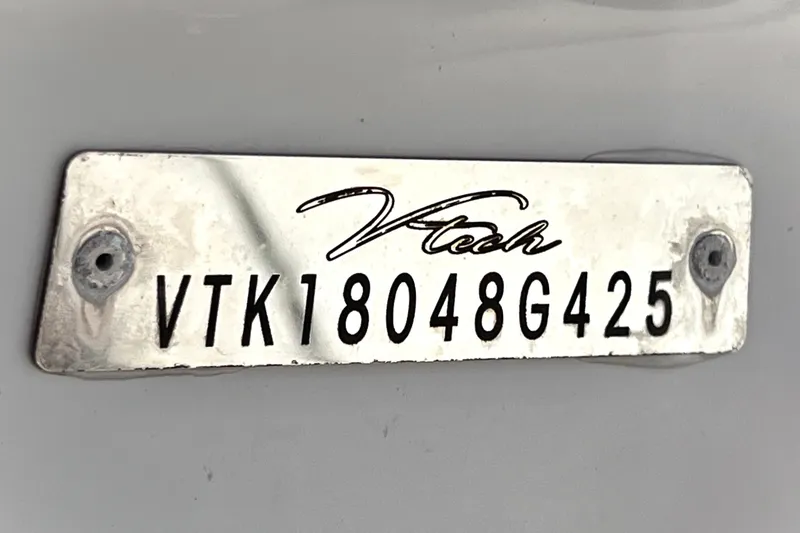 Slide: The Image of Metal plate with "Vtech" logo and serial number VTK18048G425. - 4