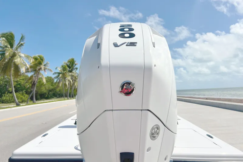 Slide: The Image of A modern outboard motor on a boat, with palm trees and the sea in the background. - 9