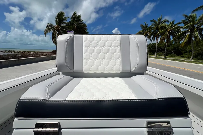 Slide: The Image of Luxurious Vtech 18 boat seat with hexagonal pattern, set against a tropical backdrop, 2025 model. - 34