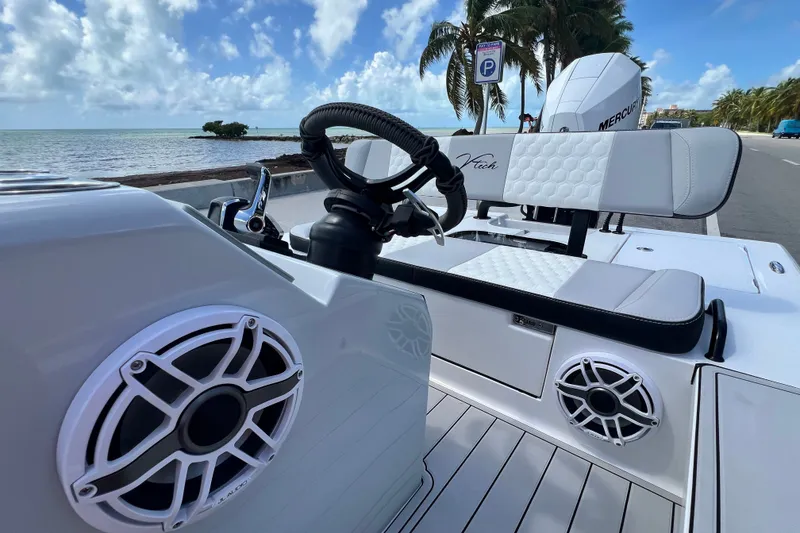 Slide: The Image of Luxury Vtech 18 boat interior with speakers, steering wheel, and seating, 2025 model. - 38