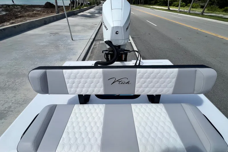 Slide: The Image of 2025 Vtech 18 boat seats with hexagonal pattern, parked near a coastal road. - 42