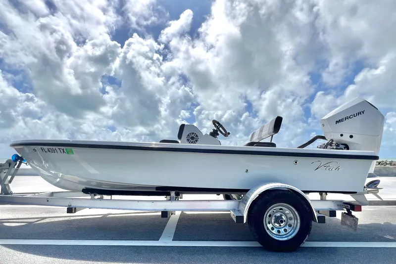 Slide: The Image of Custom Vtech 18 Flats 2025 boat on trailer under cloudy sky. - 15
