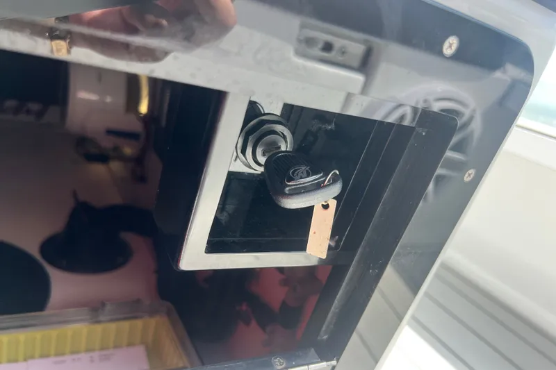 Slide: The Image of Key inserted in Vtech 18 device, model year 2025, with reflective surface. - 74