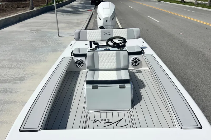 Slide: The Image of Modern Vtech 18 boat, 2025 model, with sleek design and comfortable seating on a sunny street. - 30