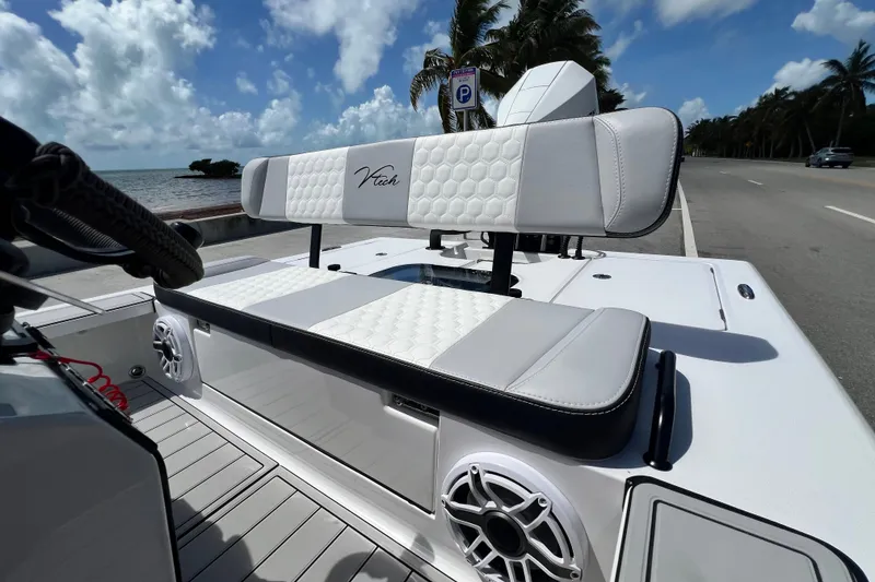 Slide: The Image of Vtech 18 boat interior, 2025 model, featuring stylish seating and speaker system by the ocean. - 41
