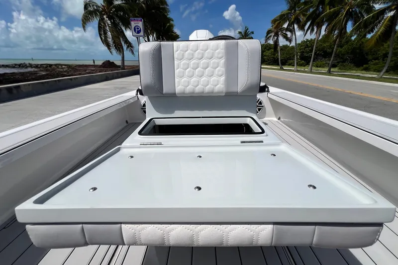 Slide: The Image of Luxury Vtech 18 boat interior with white seating, ocean view, palm trees, and clear sky, 2025 model. - 35