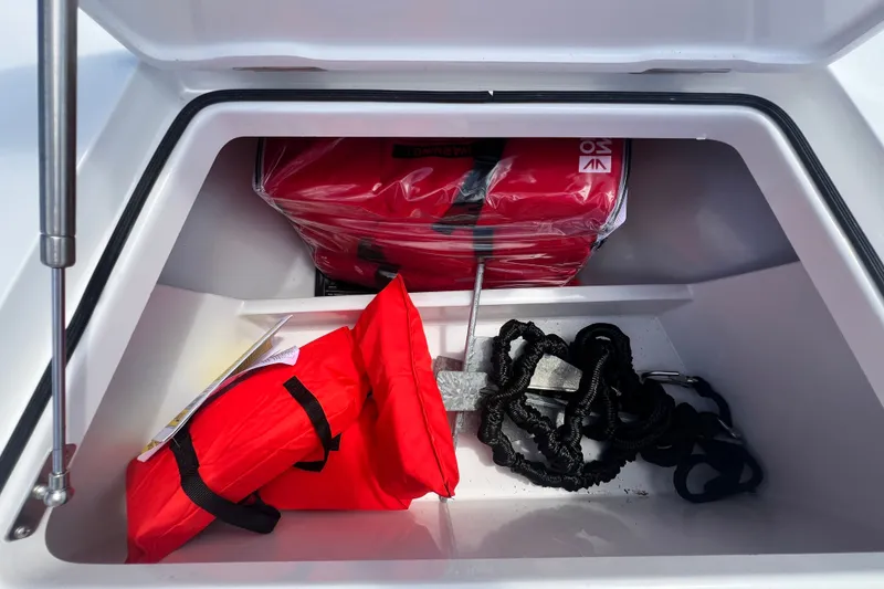 Slide: The Image of Storage compartment with red life jackets and anchor in a Vtech 18, 2025 model boat. - 68