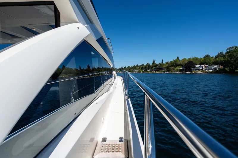 Slide: The Image of Side view of 2015 Absolute 56 STC yacht cruising on a serene lake. - 61