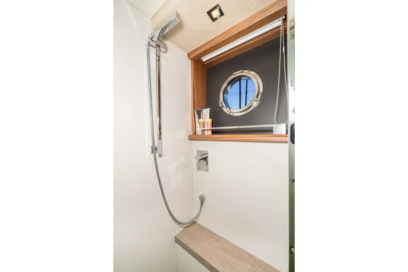 Slide: The Image of Luxurious shower area in 2015 Absolute 56 STC yacht with porthole and modern fixtures. - 42