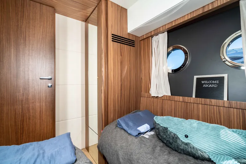 Slide: The Image of Cozy cabin interior of 2015 Absolute 56 STC yacht with portholes and wooden finish. - 45