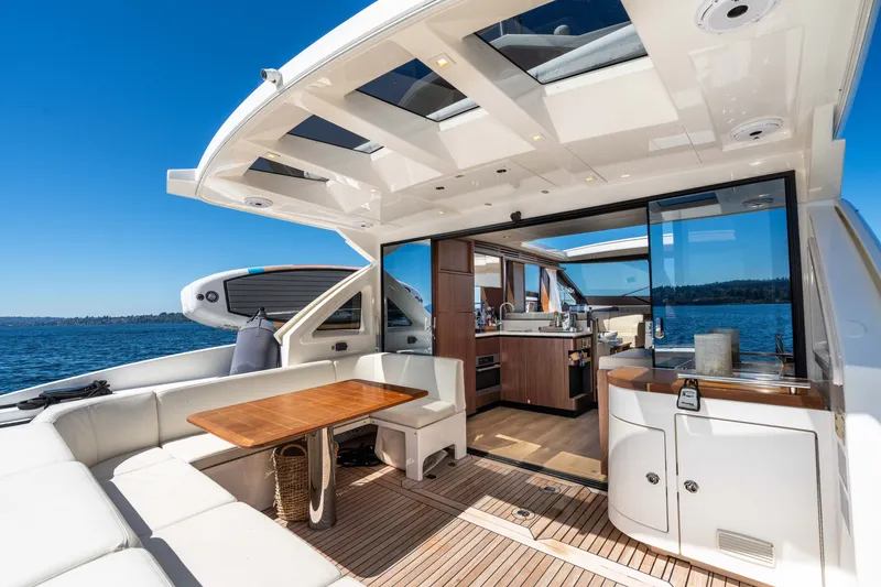 Slide: The Image of Luxurious 2015 Absolute 56 STC yacht interior with open deck, dining area, and scenic ocean view. - 59
