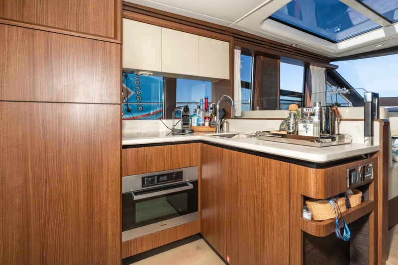 Slide: The Image of Luxurious kitchen interior of 2015 Absolute 56 STC yacht with modern wood cabinetry and appliances. - 25