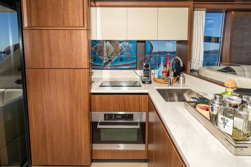 Slide: The Image of Luxurious kitchen interior of 2015 Absolute 56 STC yacht with modern appliances and wooden cabinetry. - 26