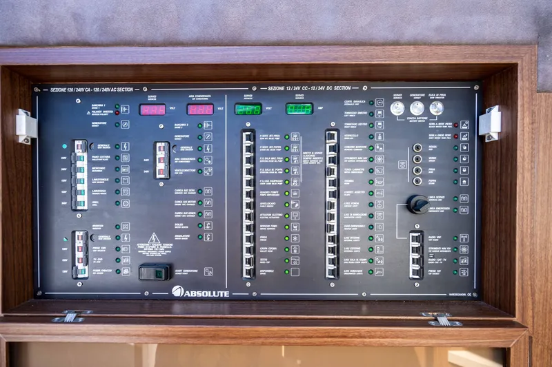 Slide: The Image of Electrical control panel of a 2015 Absolute 56 STC yacht, featuring switches and indicators. - 33