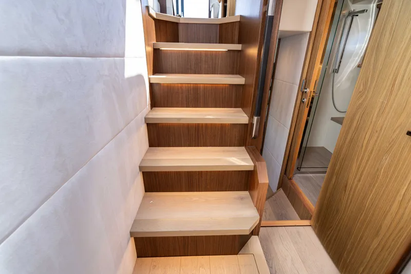 Slide: The Image of Staircase inside 2015 Absolute 56 STC yacht, featuring wooden steps and modern design. - 52