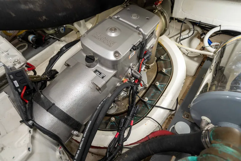 Slide: The Image of Engine compartment of a 2015 Absolute 56 STC yacht, showcasing mechanical components and wiring. - 72