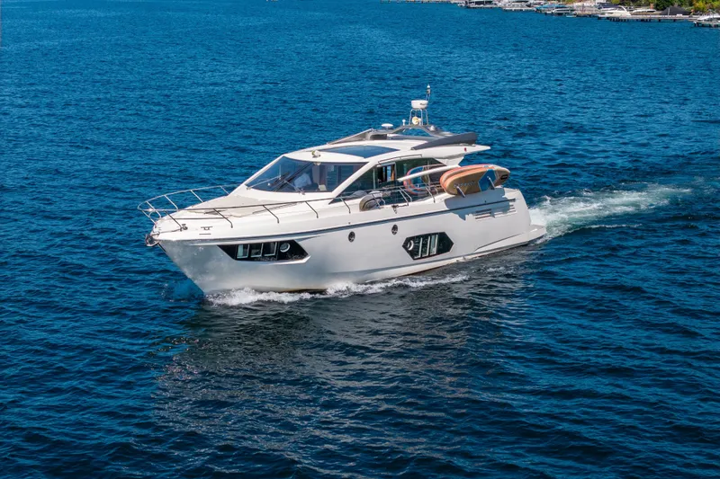 Slide: The Image of Luxurious 2015 Absolute 56 STC yacht cruising on blue ocean waters. - 13