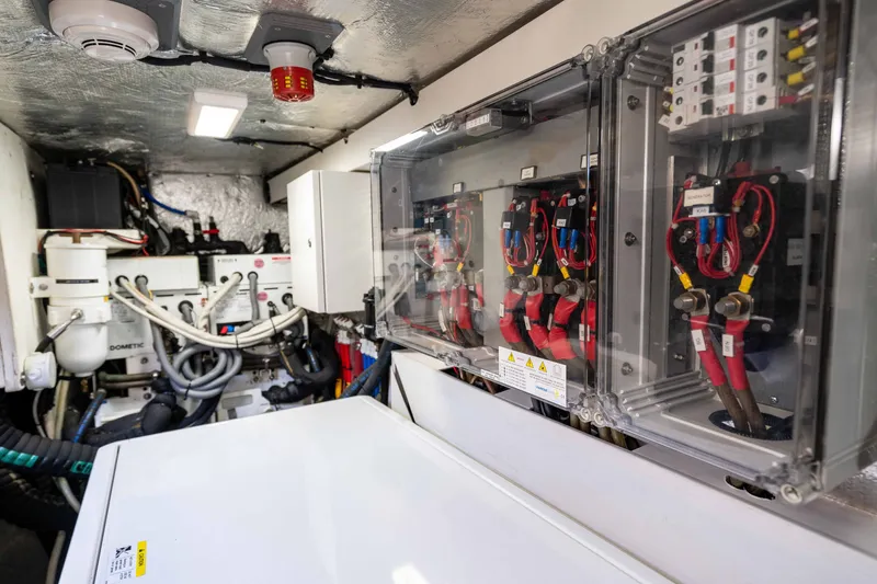 Slide: The Image of Engine room of 2015 Absolute 56 STC yacht, showcasing electrical systems and wiring. - 76