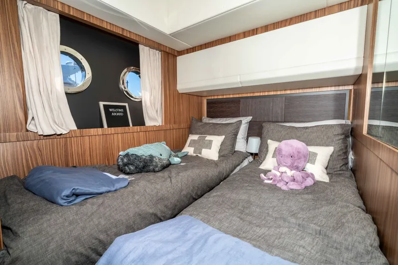 Slide: The Image of Cozy twin cabin on 2015 Absolute 56 STC yacht with plush bedding and porthole windows. - 43