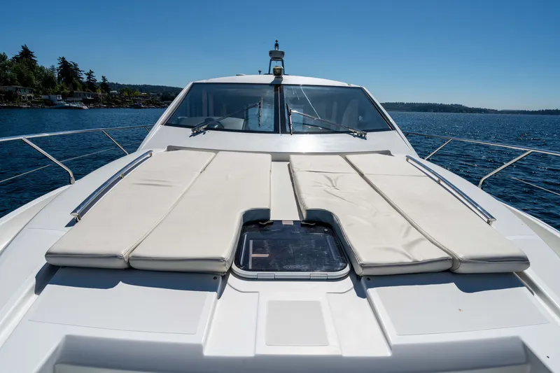 Slide: The Image of Luxury Absolute 56 STC yacht deck with sunbathing area, 2015 model, on serene water. - 64