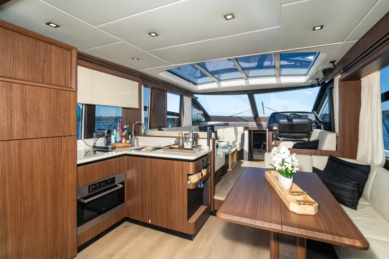 Slide: The Image of Luxurious interior of 2015 Absolute 56 STC yacht with modern kitchen and seating area. - 24