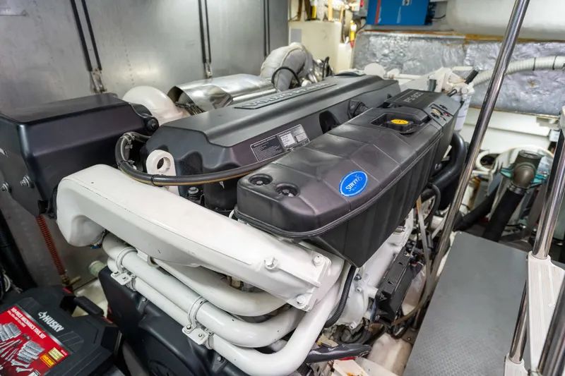 Slide: The Image of Engine room of a 2015 Absolute 56 STC yacht, showcasing detailed machinery components. - 68
