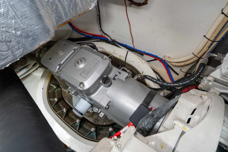 Slide: The Image of Engine room of a 2015 Absolute 56 STC yacht, showcasing mechanical components and wiring. - 71