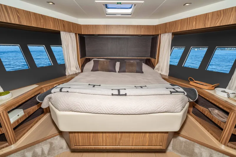 Slide: The Image of Luxurious cabin interior of 2015 Absolute 56 STC yacht with panoramic windows and cozy bedding. - 46